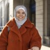 muslim-woman-with-hijab-leaving-hotel-smiling-while-being-vacation